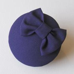 Purple bow cocktail hat.